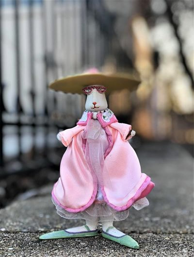 bunny in pink gown, large hat, glasses, very long feet