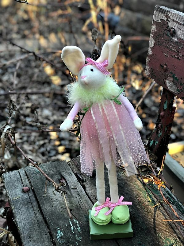 tall thin bunny in flowing pink dress, very long legs, big green shoes 