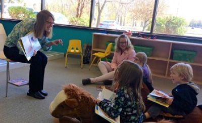 Nancy Loewen reading to kids at Gigi's Playhouse